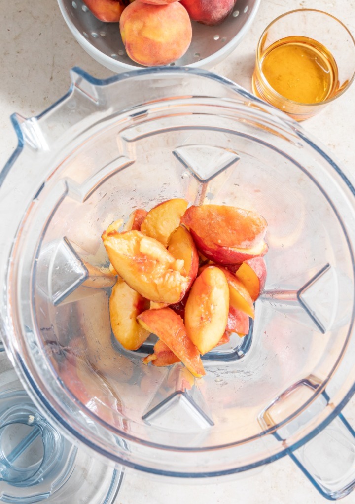 Fresh sliced peaches in a blender ready to make a puree. 