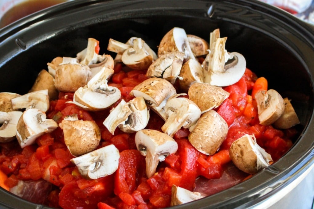 Vegetables and beef in a slow cooker. 