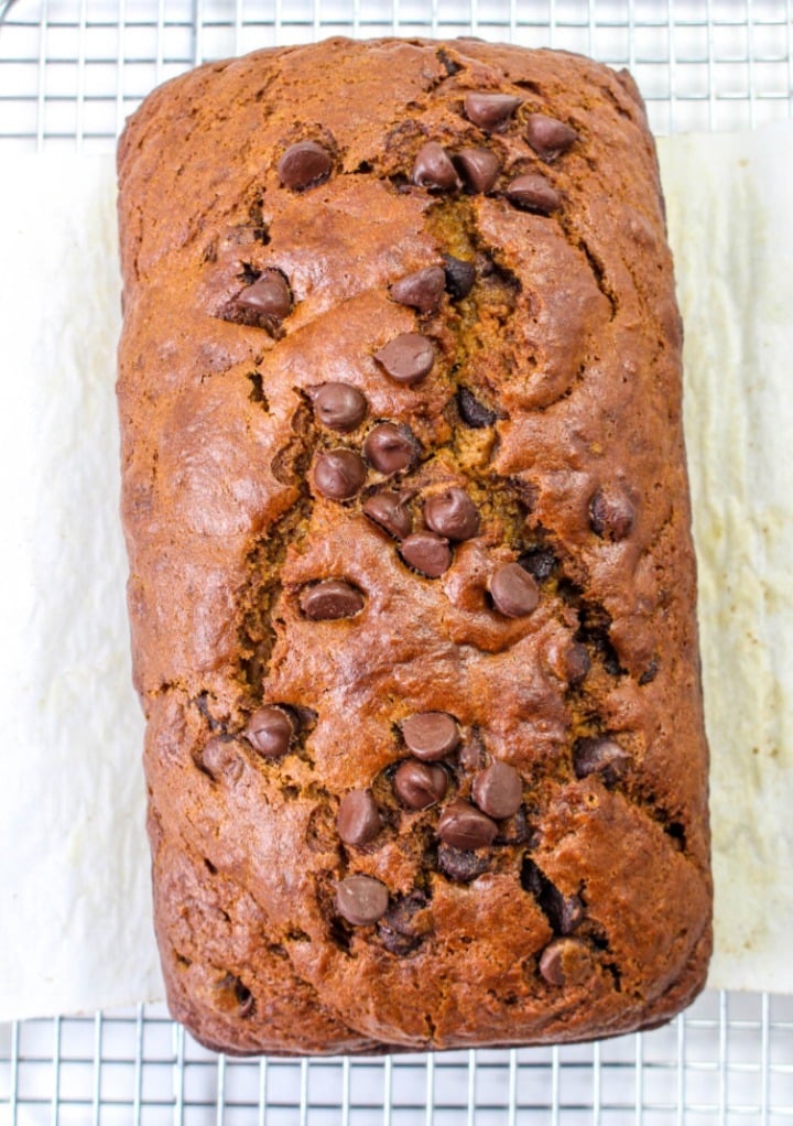 Pumpkin bread with chocolate chips on a cooling rack. 