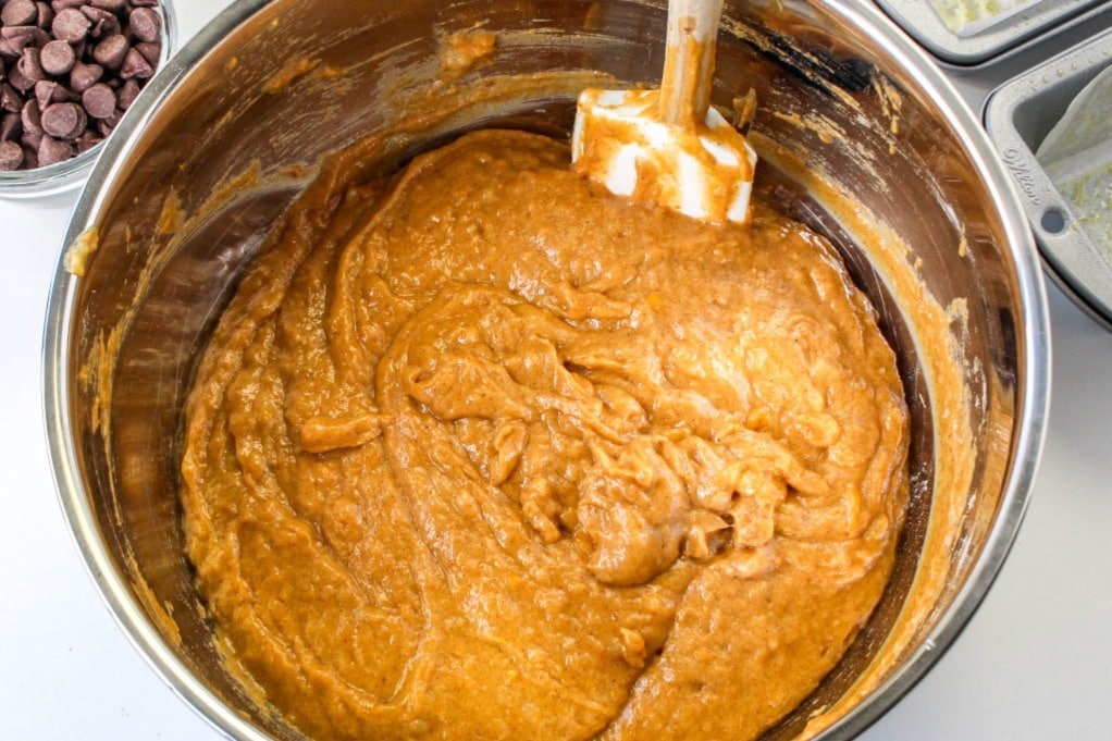 Pumpkin bread batter in a stainless steel mixing bowl. 