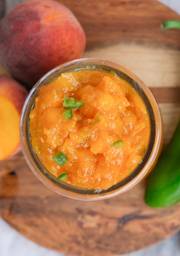 Tope view of peach jam in a small jar. 