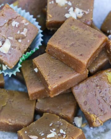 Pumpkin fudge squares with some topped with walnuts.