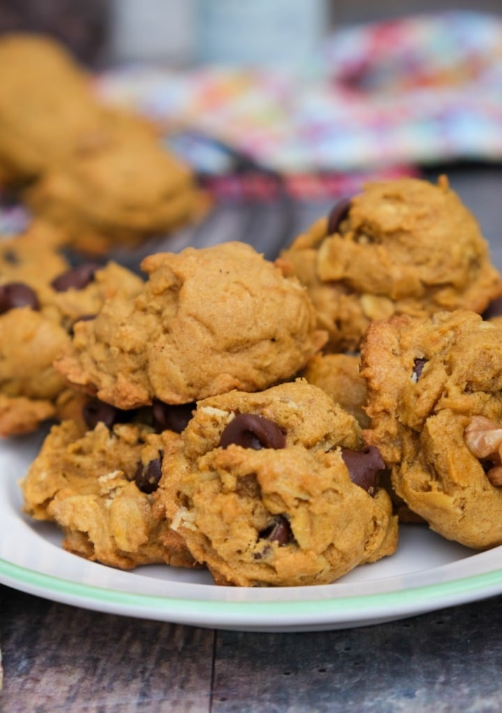 Homemade cookies on a white plate with a green rim on the plate. 