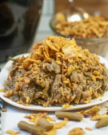 Green bean casserole recipe on a white serving plate that has beencooked in an air fryer.