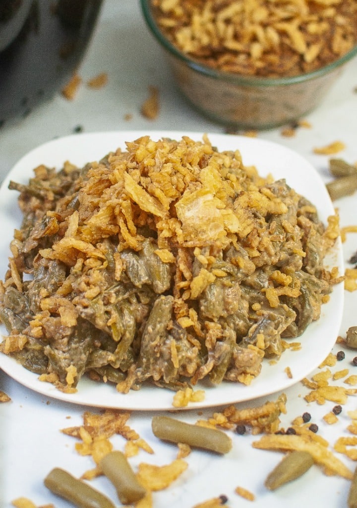 Serving dish of green bean casserole topped with French fried onions. 