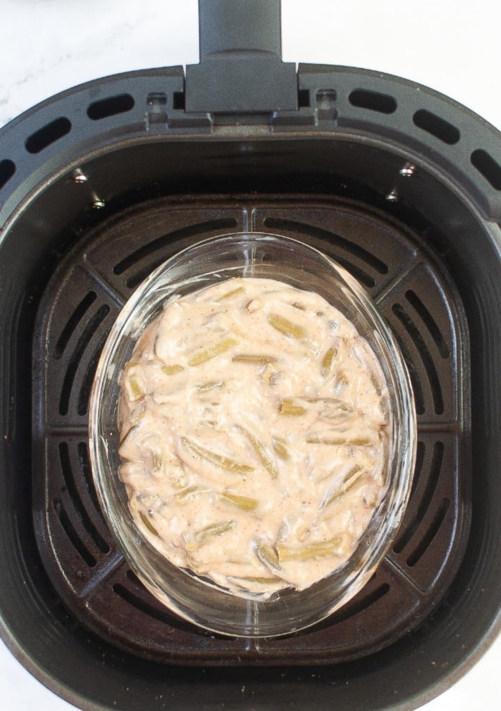 Small baking dish placed in the center of an air fryer.