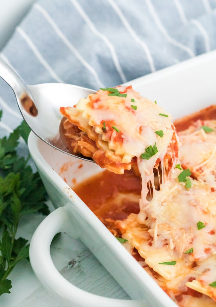 Easy lasagna made with ravioli in a white casserole dish. 