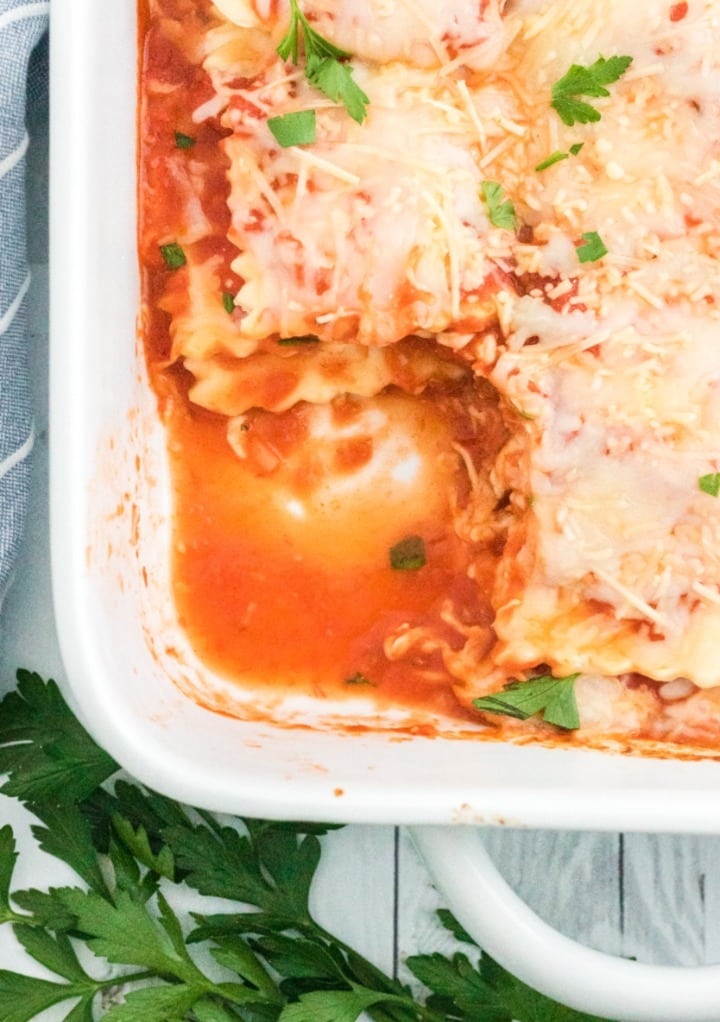 A casserole dish with a portion of the lasagna removed. 