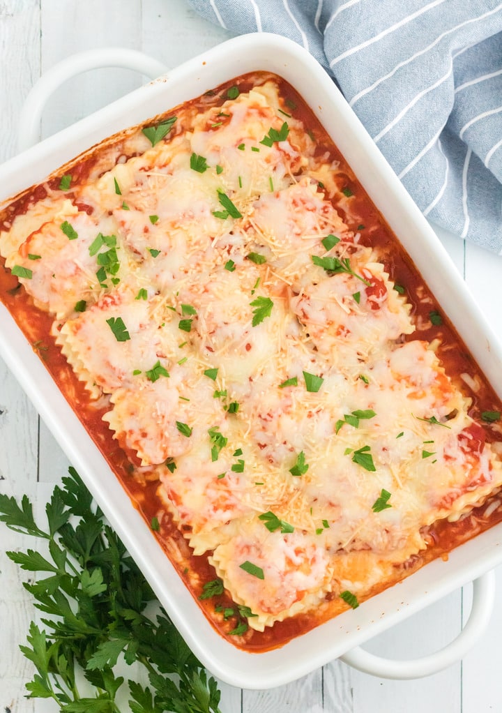 Baked lasagna topped with chopped parsley ready to serve. 