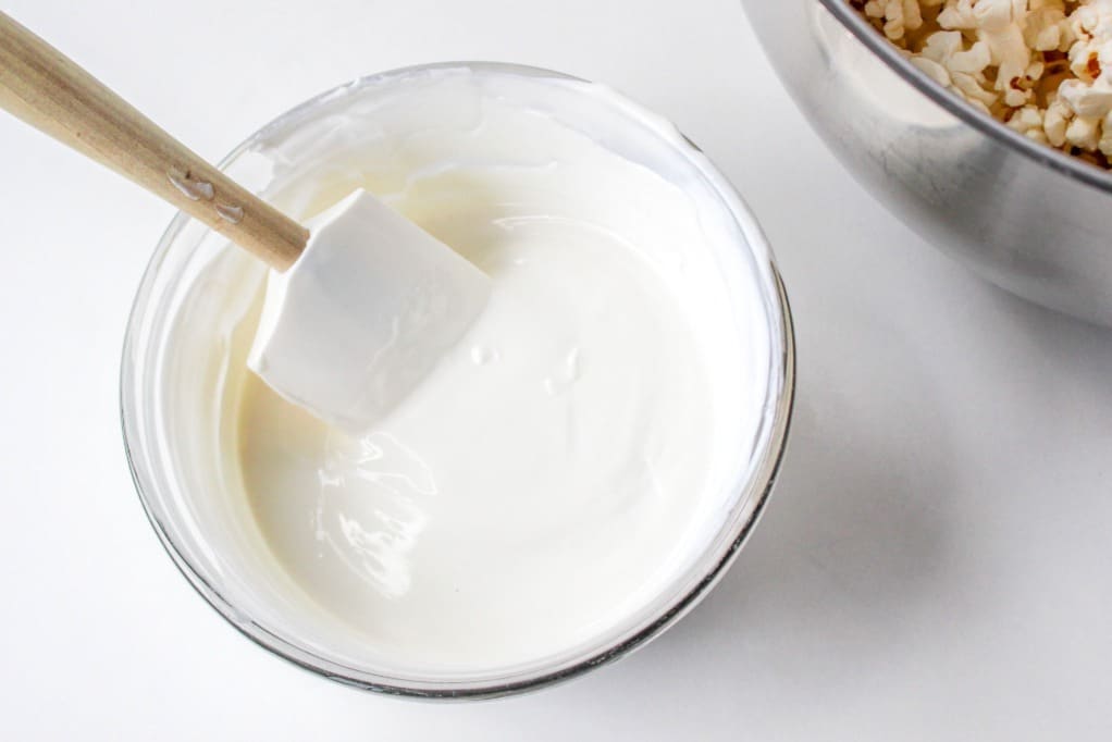 Melted white chocolate in a small mixing bowl.