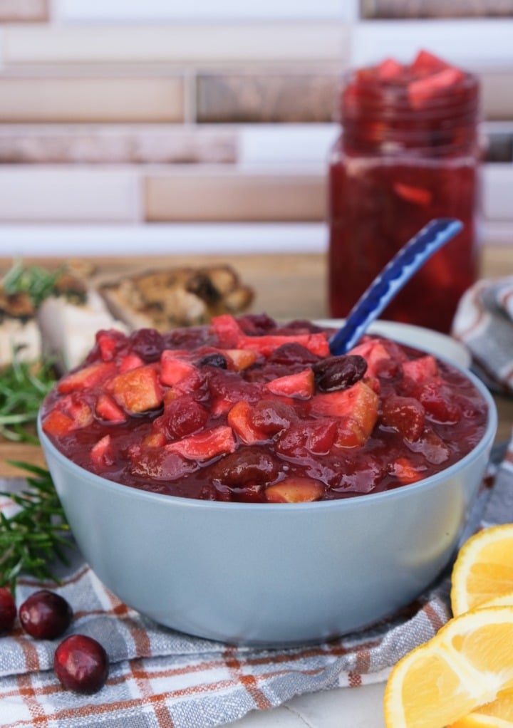 Homemade apple cranberry chutney in a light blue-gray serving bowl. 