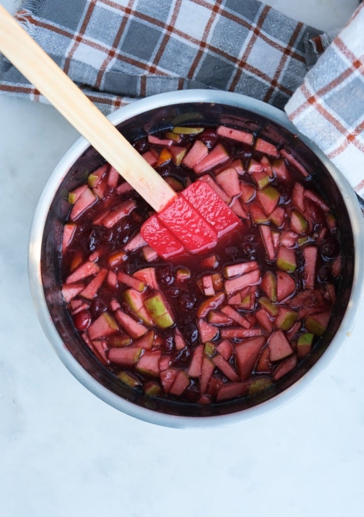 Cooked apple cranberry chutney in a saucepan. 