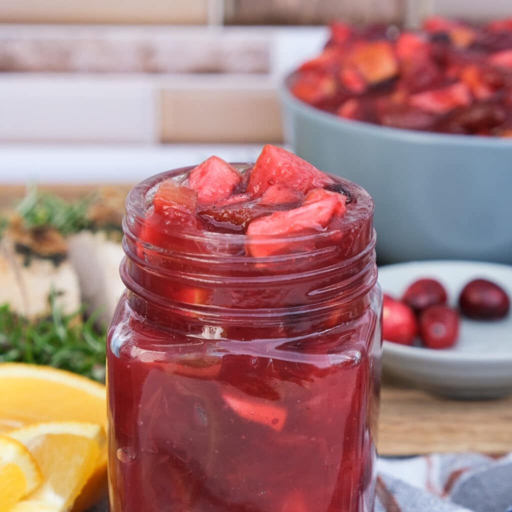Cranberry condiment in a small clear mason jar.
