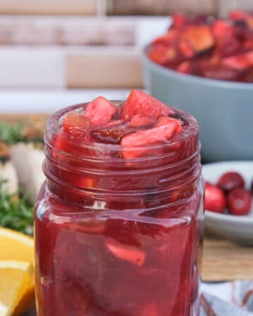 Cranberry condiment in a small clear mason jar.