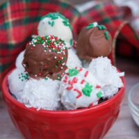 Christmas Oreo balls in a small red bowl ready to eat.