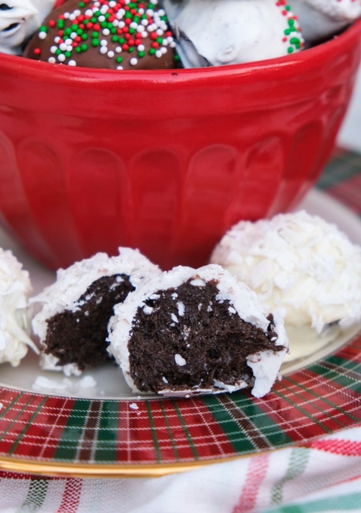 An Oreo ball sliced in half on a red and green serving dish. 