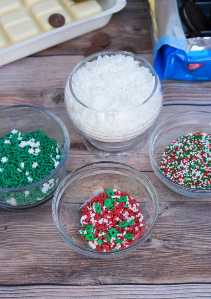 Sprinkles and shredded coconut to decorate Christmas Oreo balls. 