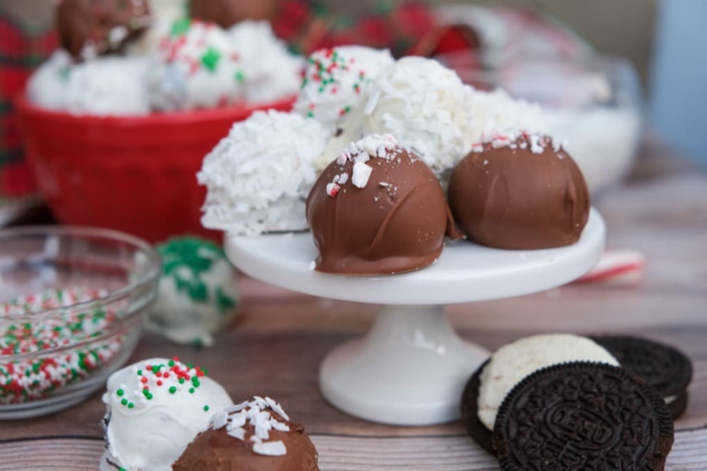 A display of Oreo balls dipped in dark and white chocolate and decorated with Christmas sprinkles. 