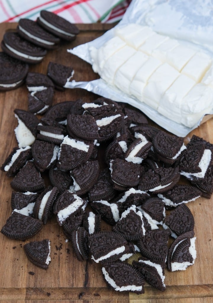 Oreo cookies broken and cream cheese sliced in chunks. 