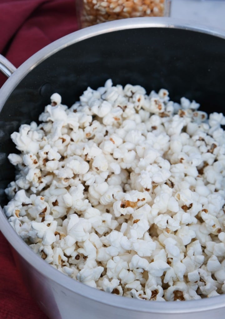 Fresh popcorn in a large pot cooked on the stovetop.