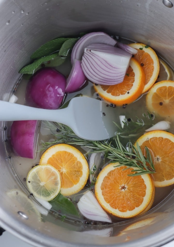 Brine mixture with sliced fruit in a stockpot with water. 