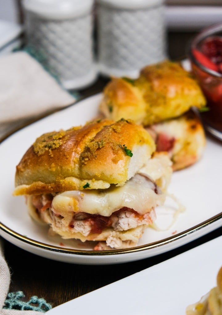 Turkey sandwich on a white serving plate. 