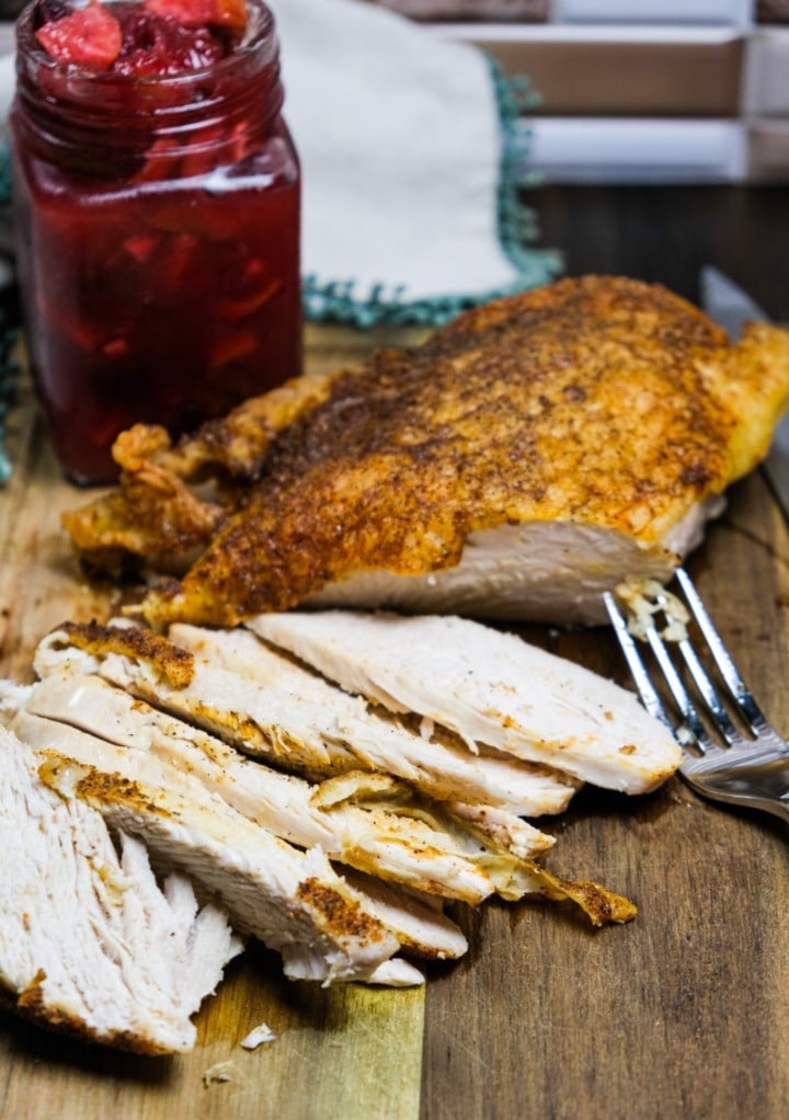 Leftover turkey from Thanksgiving on a brown cutting board.