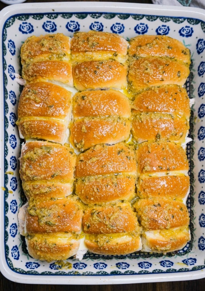 Turkey sliders recipe in a baking dish topped with mustard butter sauce. 