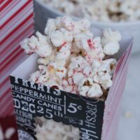 White chocolate popcorn with crushed peppermint candy in a treat bag ready to eat.