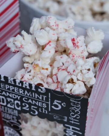 White chocolate popcorn with crushed peppermint candy in a treat bag ready to eat.