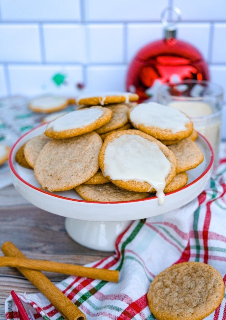 Holiday eggnog cookies baked in an air fryer on a white serving plate with a red rim.