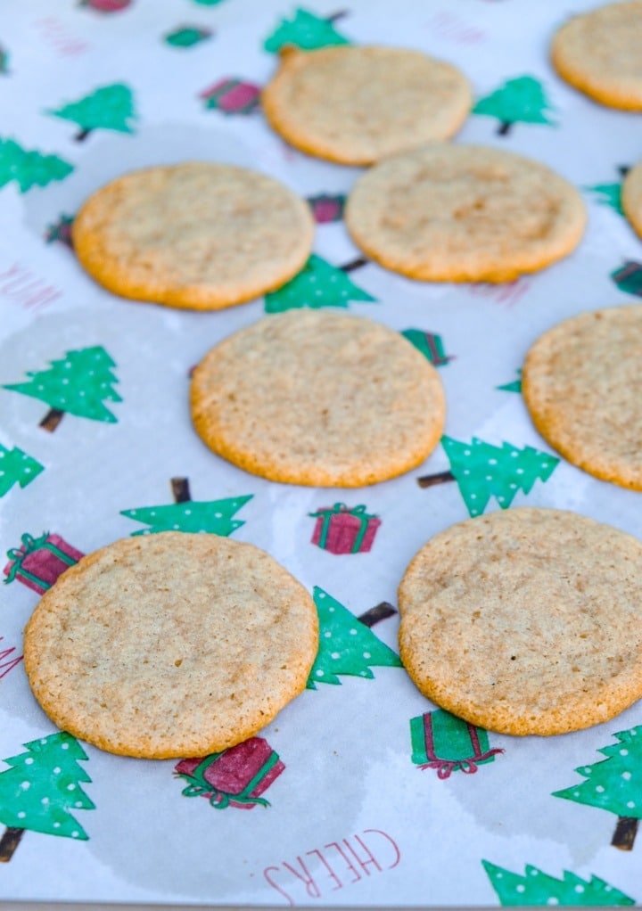 Fresh baked cookies on a parchment lined baking sheet.