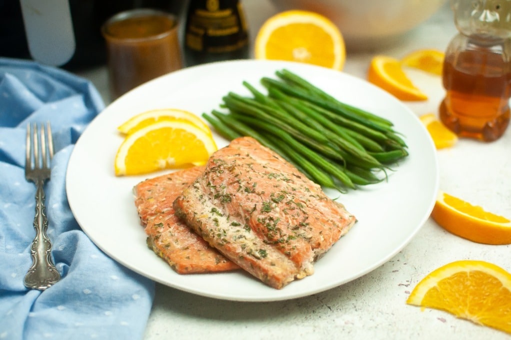 Perfect air fryer salmon fillets on a dinner plate ready to enjoy. 