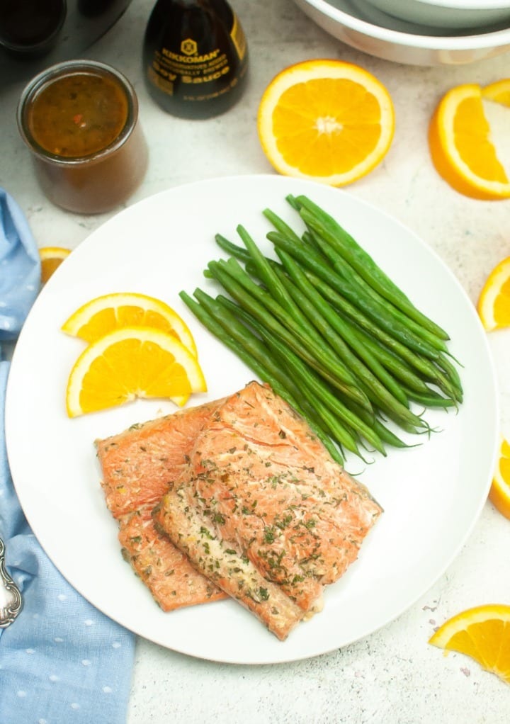 Air fryer salmon fillets on a dinner plate ready to eat. 