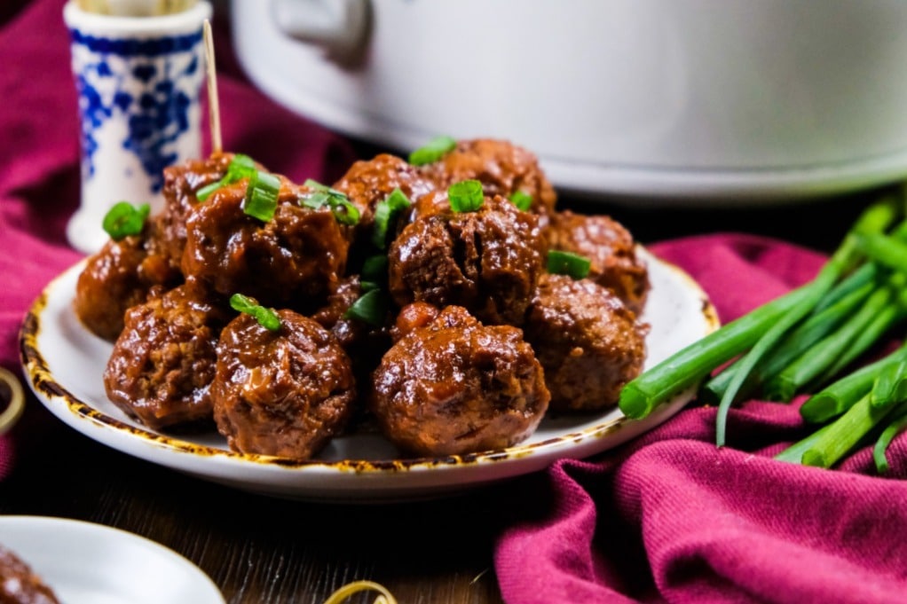 A plate full of meatballs cooked in a slow cooker. 