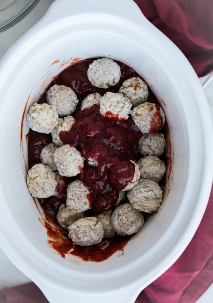 Meatballs in a slow cooker with cranberry and bbq sauce. 