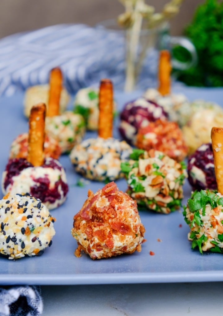 Mini cheese ball bites on a blue serving plate. 