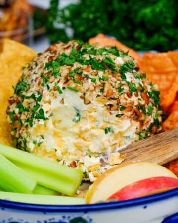 Low carb cheese ball on a serving dish with vegetables and fruit.
