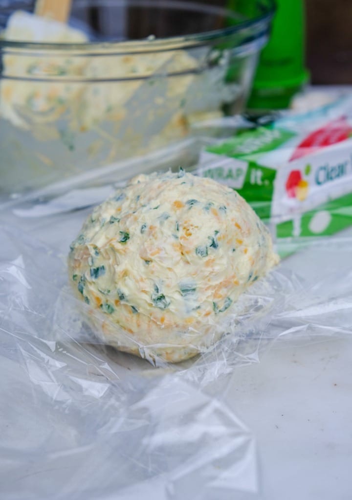 Cream cheese mixture formed into a ball ready to wrap in plastic. 