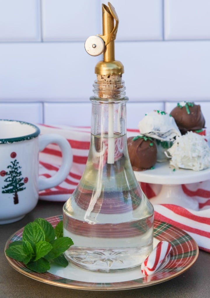 Homemade peppermint syrup in a clear glass container. 