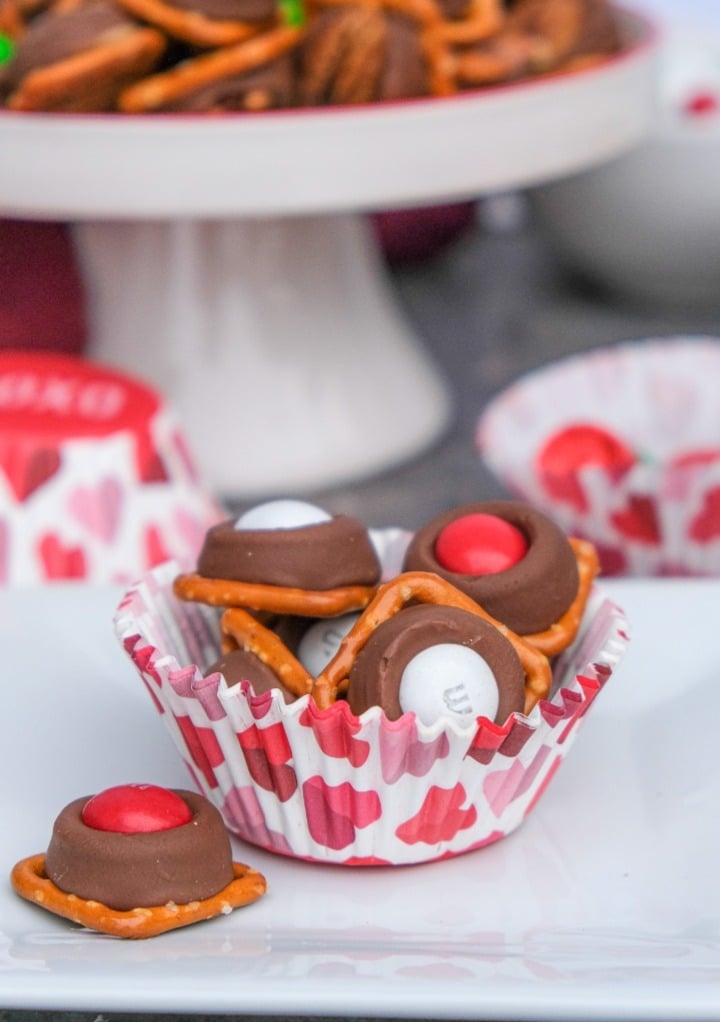 Valentine rolo pretzel bites in a cupcake liner placed on a white plate. 