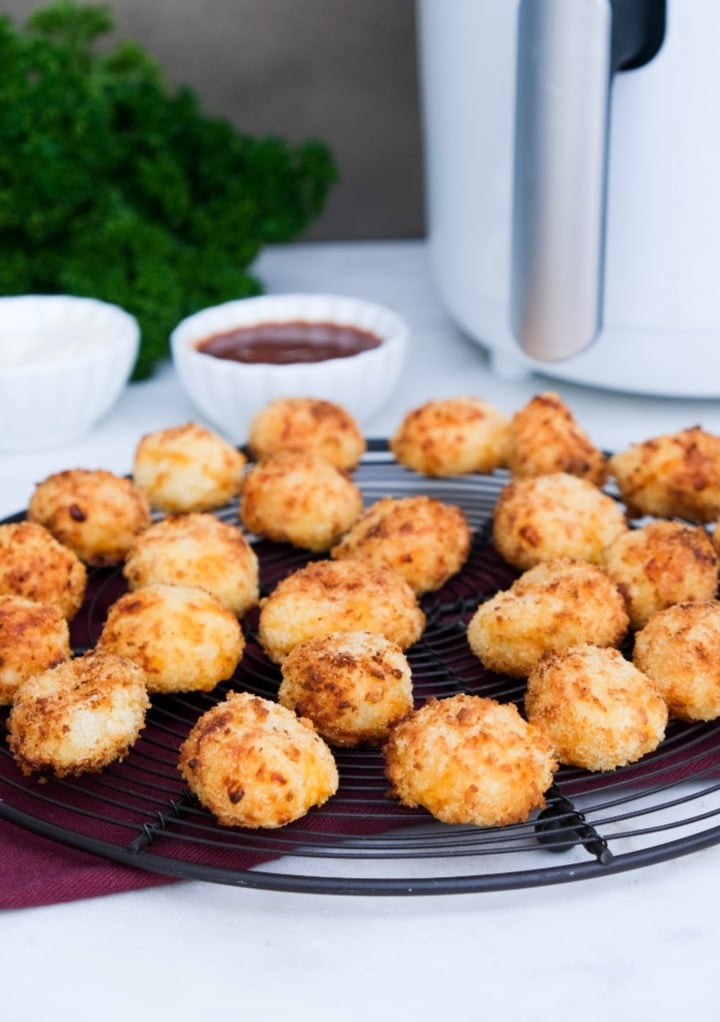 Potato bites on a cooling rack after cooked in an air fryer. 