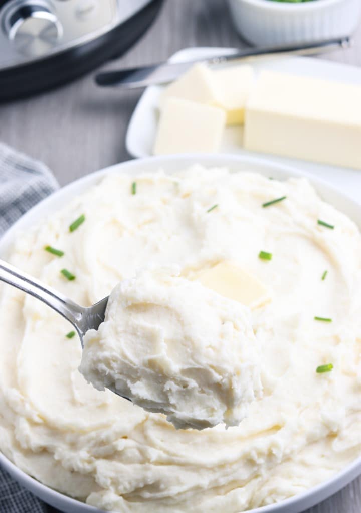 Spoonful of creamy potatoes with a sprinkle of chives. 