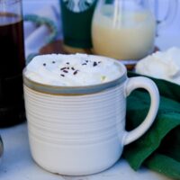 Copycat Starbucks white chocolate mocha in a ceramic mug with a green rim.