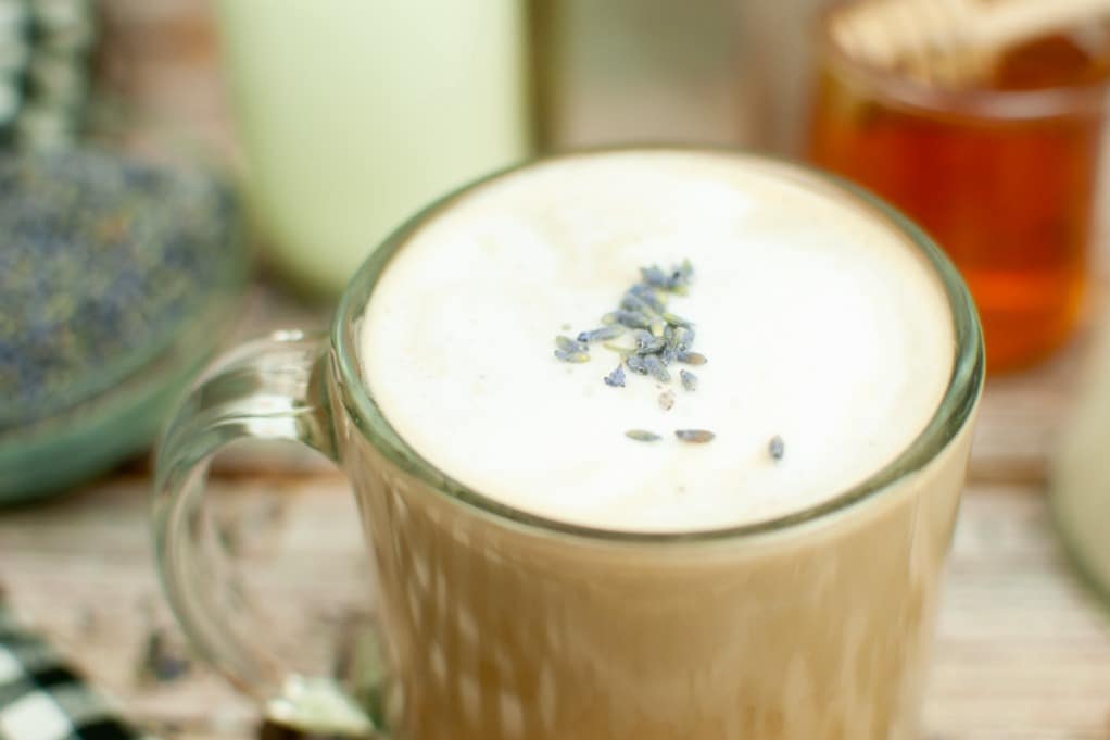 Latte topped with cream an lavender buds.