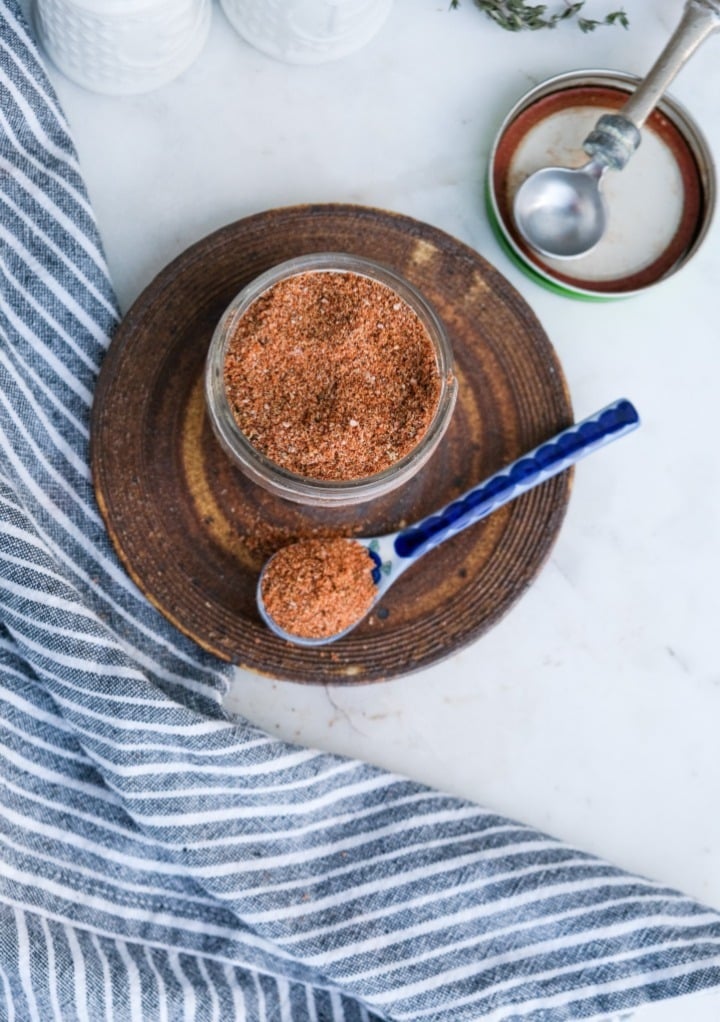 Top view of pork rub in a small mason jar with the lid on the side. 