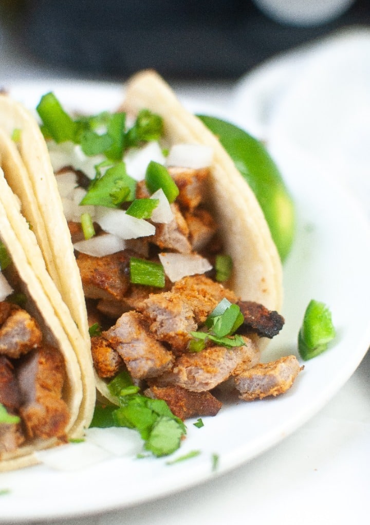 Close view of diced pork in corn tortillas ready to eat. 