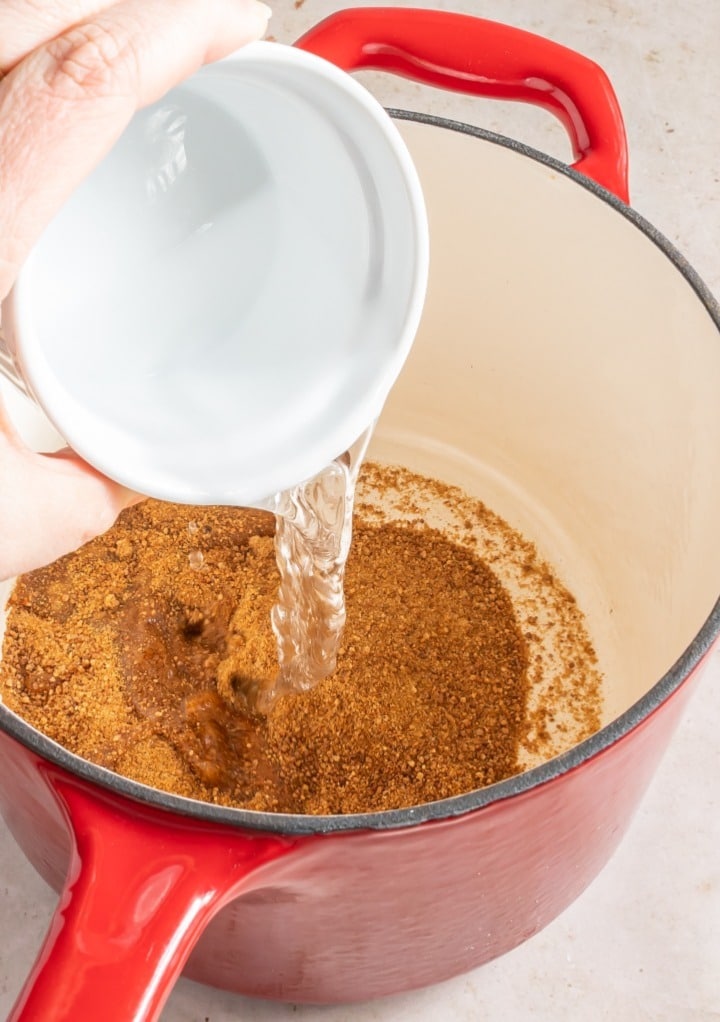 Mixing water with coconut sugar in a small saucepan. 