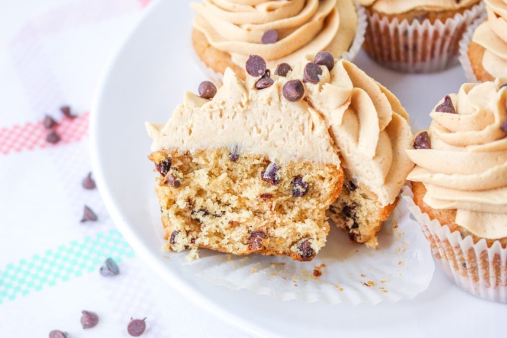 Homemade cupcakes with peanut butter frosting on a white serving dish. 