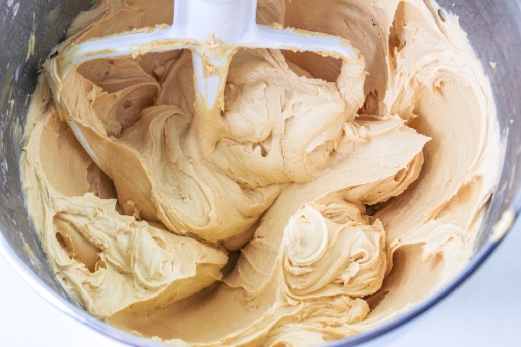 Prepared peanut butter frosting in a mixing bowl. 